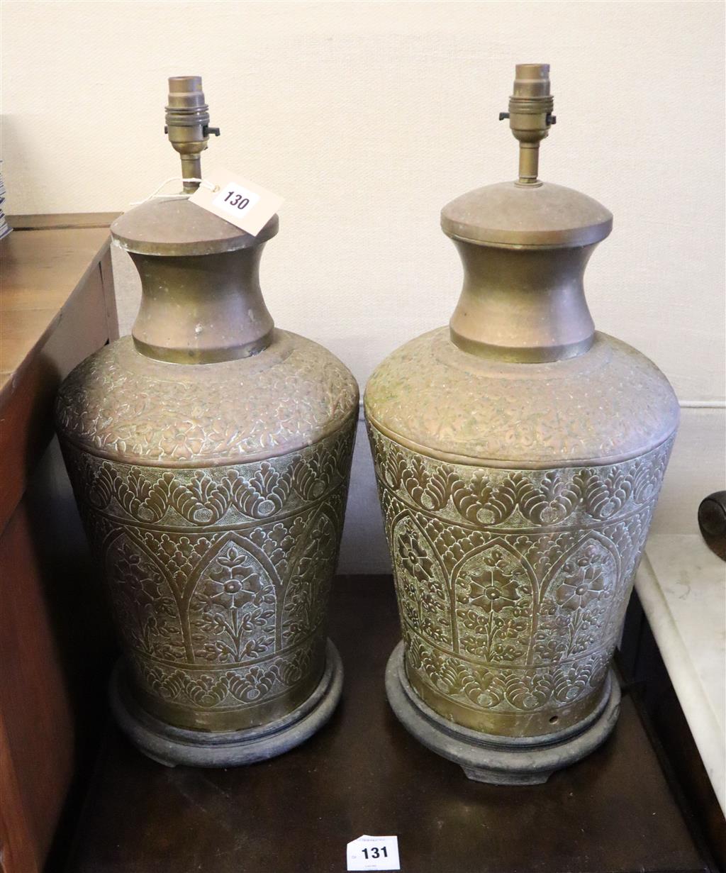A pair of Indian embossed brass baluster shaped table lamps, height 50cm
